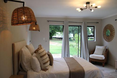 a bedroom with a white bed and a window at The White Castle in Chartwell