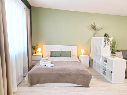 a bedroom with a large bed with towels on it at Dunes Trail 2 in Melnragė