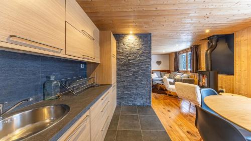 a kitchen with a sink and a living room at Atalaya Chalet - Panoramic View in Saint-Jean-de-Sixt
