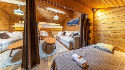 a room with a bed and a couch in a room at Atalaya Chalet - Panoramic View in Saint-Jean-de-Sixt