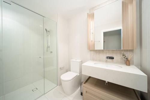 a bathroom with a toilet and a sink and a shower at Queens Wharf 1B plus Study apt - level 29 City view in Brisbane
