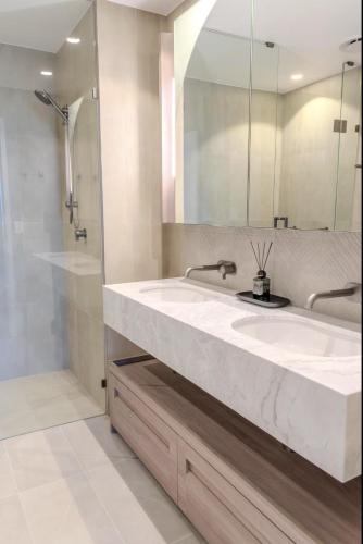 a bathroom with a large sink and a shower at 2Bed Luxe Queens Wharf Apt - Carpark and city view in Brisbane