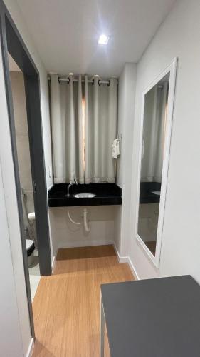 a bathroom with a toilet and a mirror at Seu Hotel in Patos