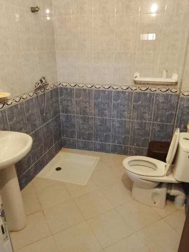 a bathroom with a toilet and a sink at Razzak in Rabat