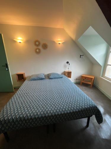 a bedroom with a large bed in a attic at studio 3- les moulins in Cherbourg en Cotentin