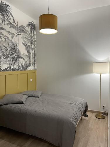 a bedroom with a bed and a lamp and a wall at Cozy Studio with Terrace in Cers