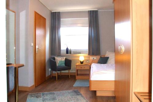 a bedroom with a bed and a desk and a window at Hotel und Gasthaus Sieling in Liebenau