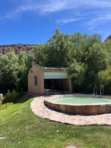 a small pool in a yard with a building at Casa Domo Juella in Juella