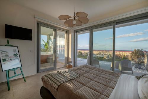 a bedroom with a bed and a large window at Villa fronte mare in Bari