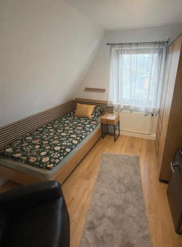 a small bedroom with a bed and a window at stayOldenburg in Oldenburg