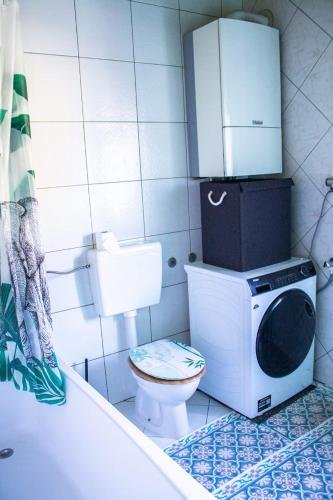 a bathroom with a toilet and a cabinet on top of it at Apartman Gajnice Zagreb in Zagreb