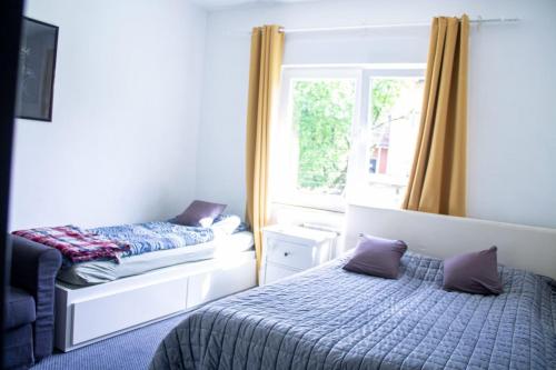 a bedroom with a bed and a window at Apartman Gajnice Zagreb in Zagreb