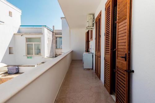 a corridor of an apartment with open doors at Il Bacio del Sole - San Foca in San Foca