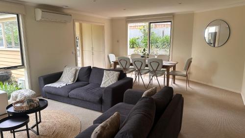a living room with a couch and a table and chairs at Las Elenas in Magpie
