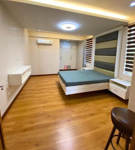 a bedroom with a bed and a wooden floor at Rathore villa in Lahore