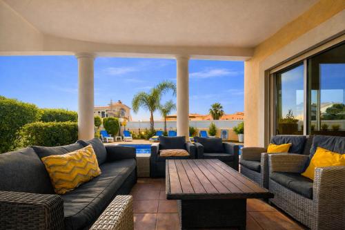 a patio with couches and a table and a pool at Sunshine - Private Pool - 8 Guests - Albufeira in Albufeira