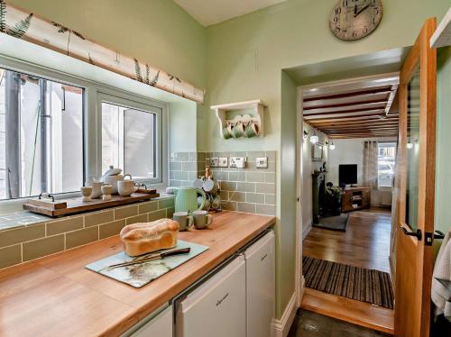a kitchen with a counter and a clock on the wall at 2 Bed in York oc-96097 in Helmsley