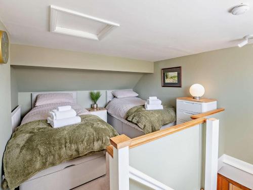 two twin beds in a room with a staircase at 2 Bed in York oc-96097 in Helmsley