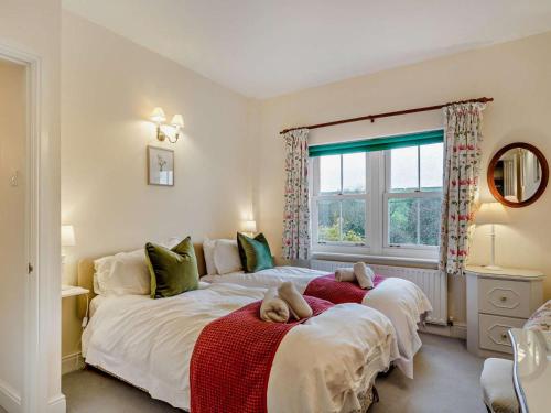 a bedroom with two beds with teddy bears on them at 2 Bed in Dorchester oc-59666 in Long Bredy