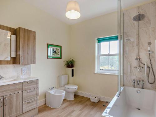 a bathroom with a tub and a toilet and a shower at 2 Bed in Dorchester oc-59666 in Long Bredy