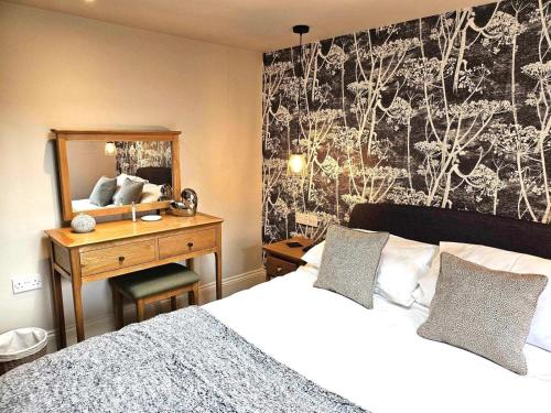 a bedroom with a bed and a desk with a mirror at 2 Bed in York oc-81551 in Welburn