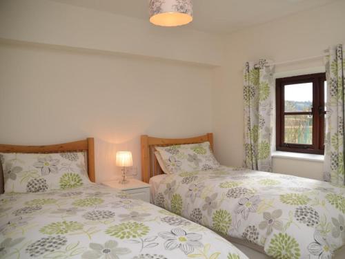 a bedroom with two beds and a window at 2 Bed in Chew Magna oc-56550 in Stowey
