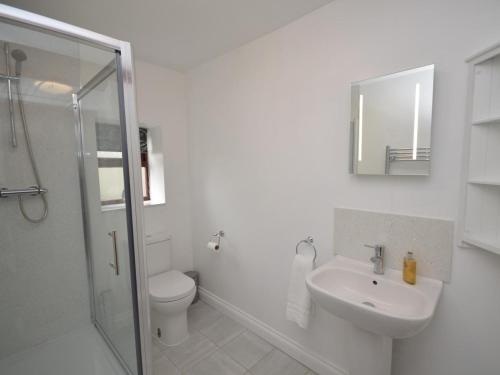 a white bathroom with a toilet and a sink at 2 Bed in Chew Magna oc-56550 in Stowey