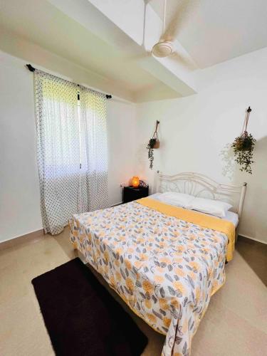 a bedroom with a bed with a comforter on it at A La Mer - Solis 3 in Varca