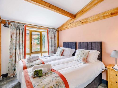 two twin beds in a room with a window at 2 Bed in Ripon oc-85510 in Masham