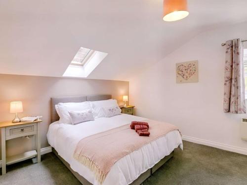 a bedroom with a bed with a red towel on it at 1 Bed in Holmfirth oc-88554 in Holmfirth