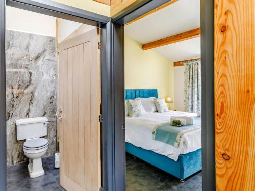 a bedroom with a king sized bed and a toilet at 1 Bed in Ripon oc-85511 in Masham