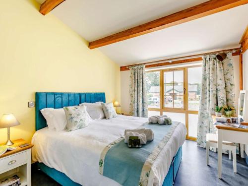 a bedroom with a large bed and a window at 1 Bed in Ripon oc-85511 in Masham