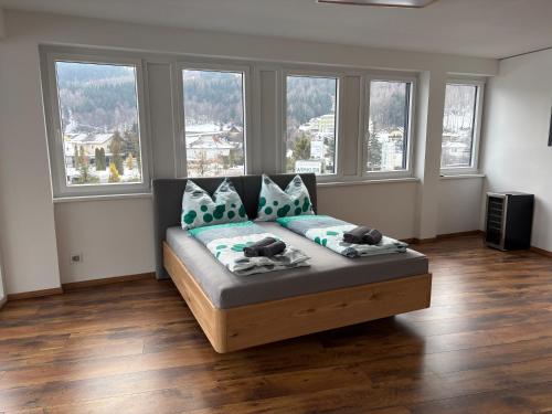 a couch in a living room with windows at Apartment Seeboden in Seeboden
