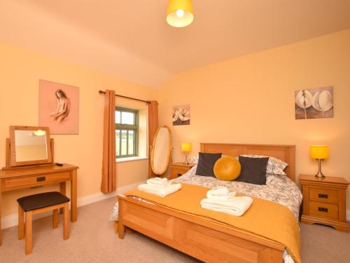 a bedroom with a bed and a mirror and a television at 2 Bed in Consett oc-smidc in Lanchester