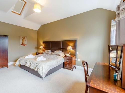 a bedroom with a large bed and a table at 3 Bed in Consett oc-29408 in Lanchester