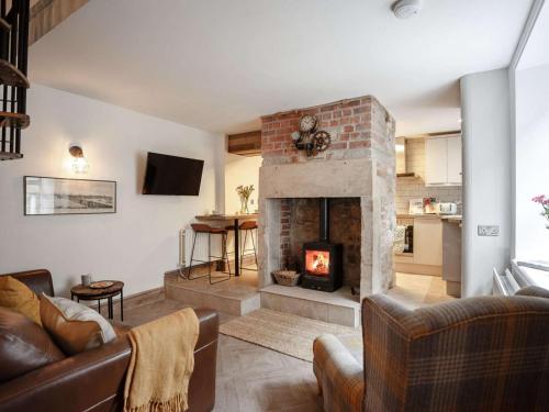 a living room with a fireplace and a couch at 2 Bed in Morpeth oc-82238 in Rothbury