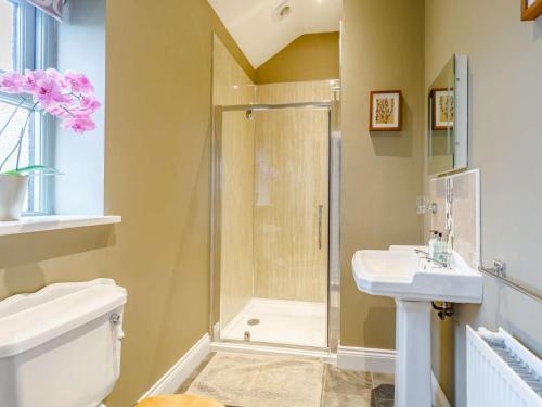 a bathroom with a shower and a toilet and a sink at 3 Bed in Consett oc-29408 in Lanchester