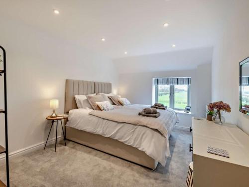 a bedroom with a large bed and a window at 4 Bed in Brough oc-93496 in Brough