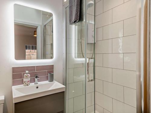 a bathroom with a sink and a glass shower at 4 Bed in Brough oc-93496 in Brough