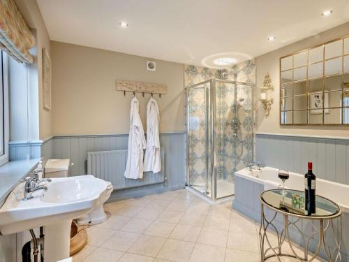 a bathroom with a sink and a tub and a shower at 2 Bed in Richmond oc-74305 in Barton
