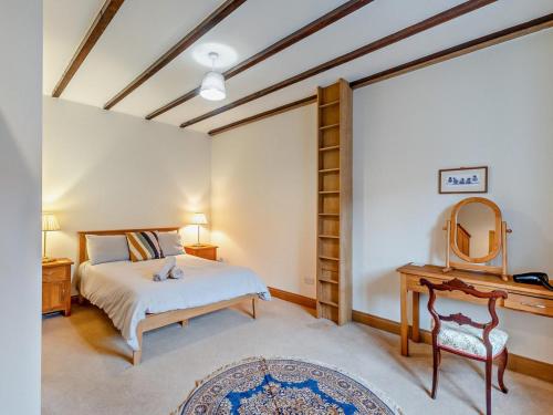 a bedroom with a bed and a mirror at 3 Bed in Cornhill -on- Tweed oc-76374 in Carham