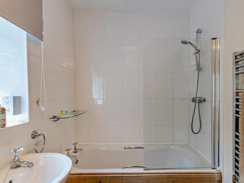a bathroom with a shower and a tub and a sink at 3 Bed in Cornhill -on- Tweed oc-76374 in Carham