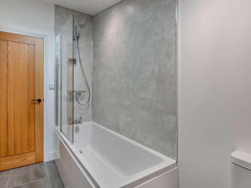a bathroom with a shower and a bath tub at 3 Bed in York oc-93898 in Tollerton