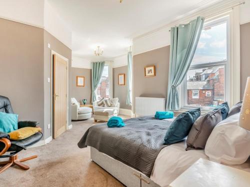 a bedroom with a large bed with blue pillows on it at 7 Bed in Bridlington oc-90787 in Bridlington