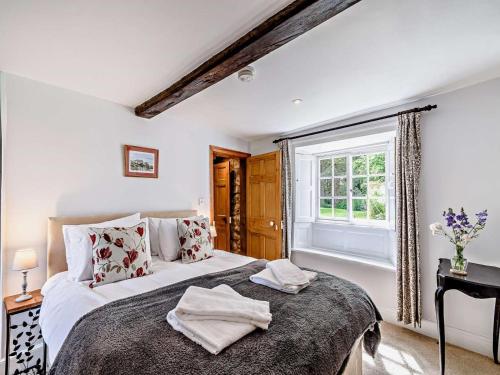 a bedroom with a large bed and a window at 8 Bed in Ripon oc-72263 in Grantley