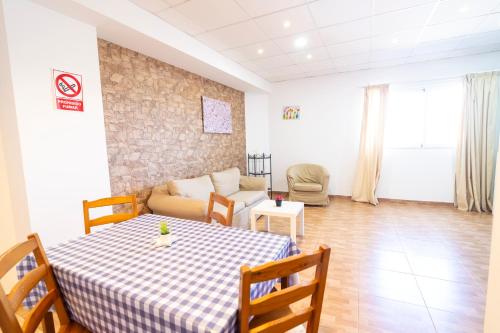 a living room with a table and a couch at Edificio Prieto VIV 2B in Puerto del Rosario