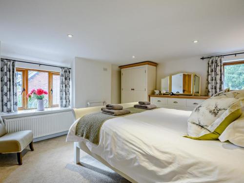 a bedroom with a large white bed and a window at 4 Bed in Lymington oc-nfl94 in Sway