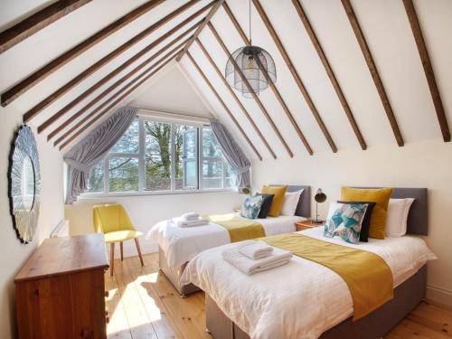two beds in a room with a attic at 3 Bed in Dorchester oc-92415 in Frome Vauchurch