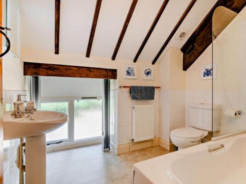 a bathroom with a toilet and a sink and a tub at 3 Bed in Dorchester oc-92415 in Frome Vauchurch