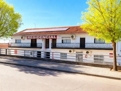 a white building with a sign on the side of it at ALOJAMENTO ELVAS LUSO ESPANHOLA in Elvas